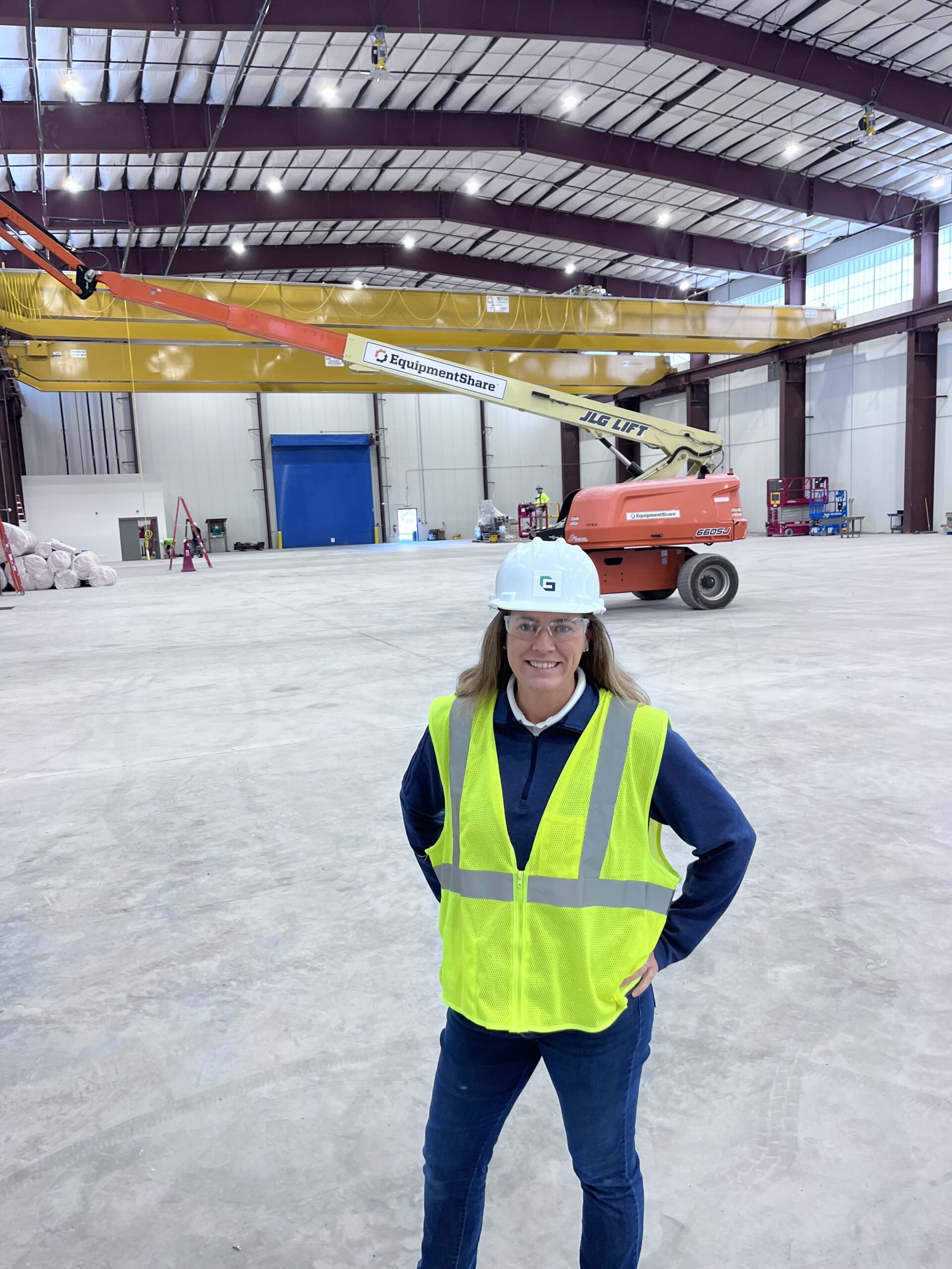Jennifer Gervais at a construction site with a crane.